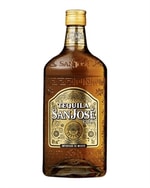 Gylden tequilaflaske foran lys baggrund